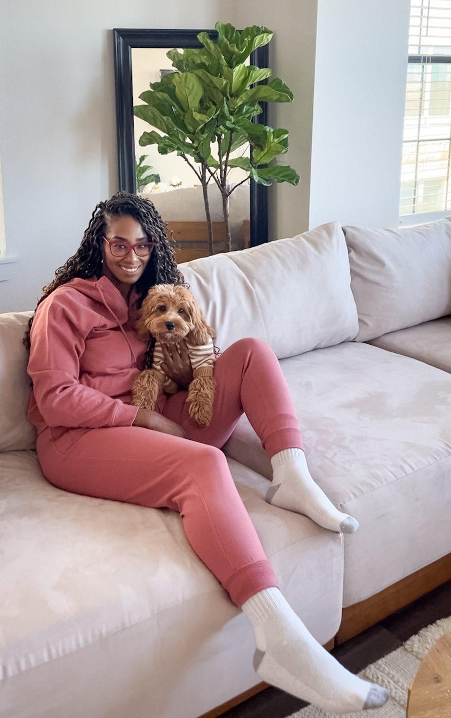 Image of Courtney, from world in four days wit her dog Arlo on sofa